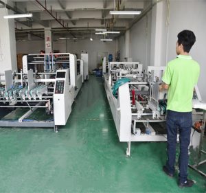 Fully automatic box gluing machine for carton assembly in a printing packaging factory | HugPak